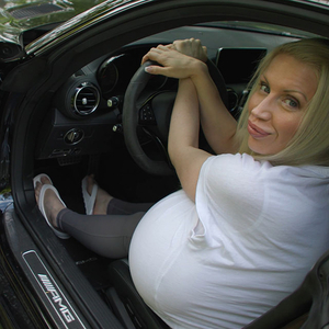 The queen of fake boobs showing you how tight it can be in a sports car