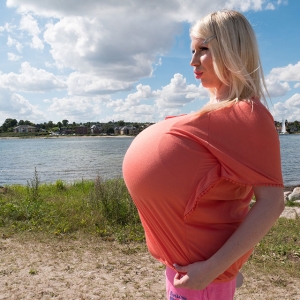 Enormous titted blonde at a beach