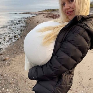 Winter beach walk with the biggest enhanced breasts in the world