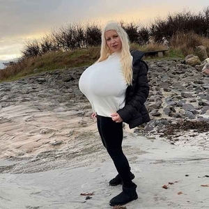 Winter beach walk with the biggest enhanced breasts in the world