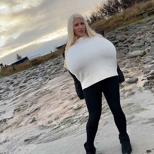 Winter beach walk with the biggest enhanced breasts in the world