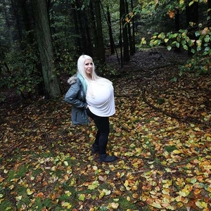 Autumn season and biggest boobed blonde Beshine walks through the forests