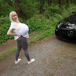 Getting into a sports car with the largest boobs in the world