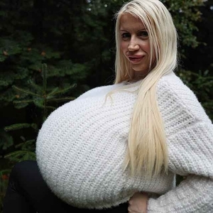 The biggest breasts in the world stretch a wool sweater